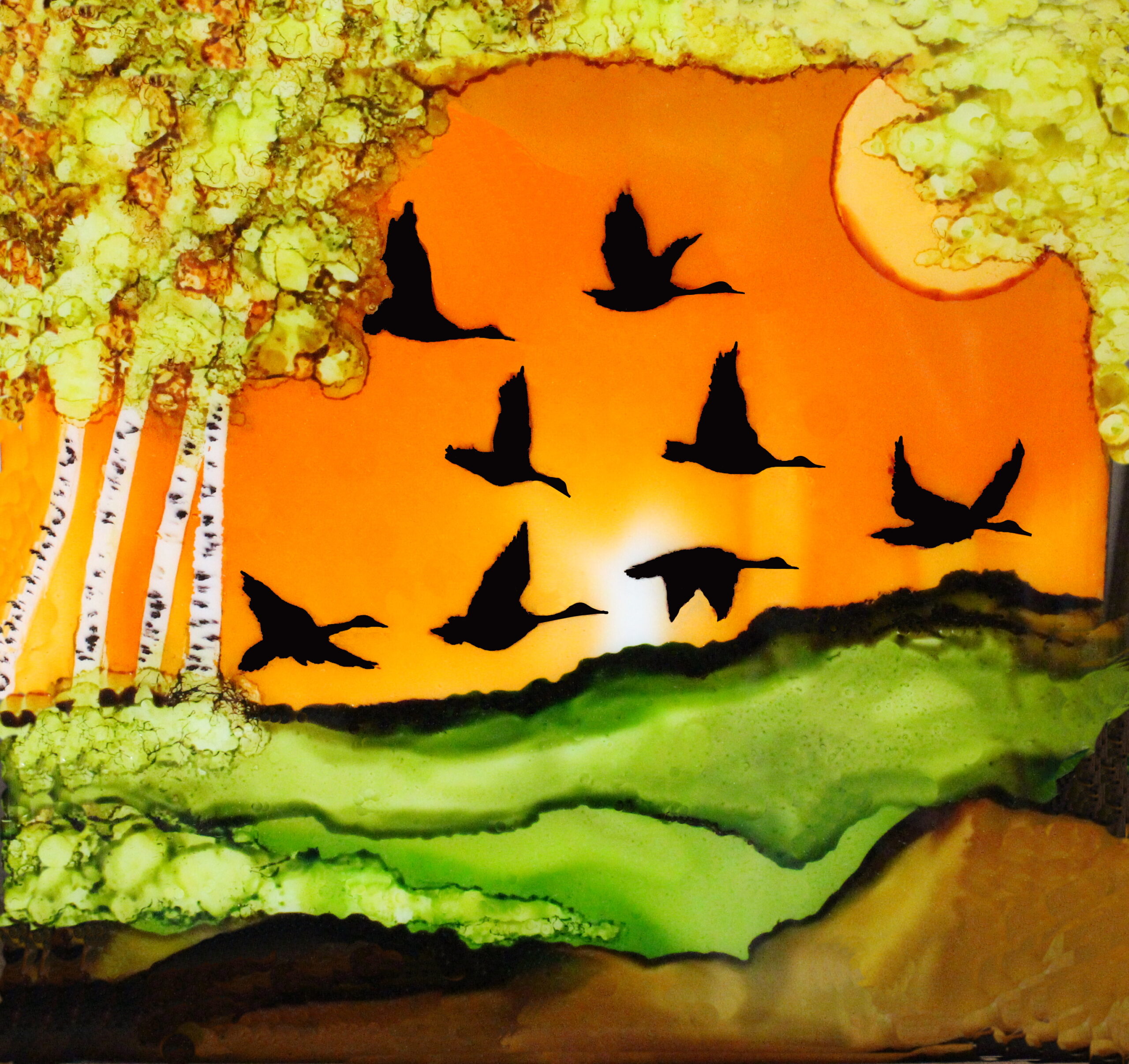 Alcohol ink artwork of birds flying in a sunset by Betty Sawatzky